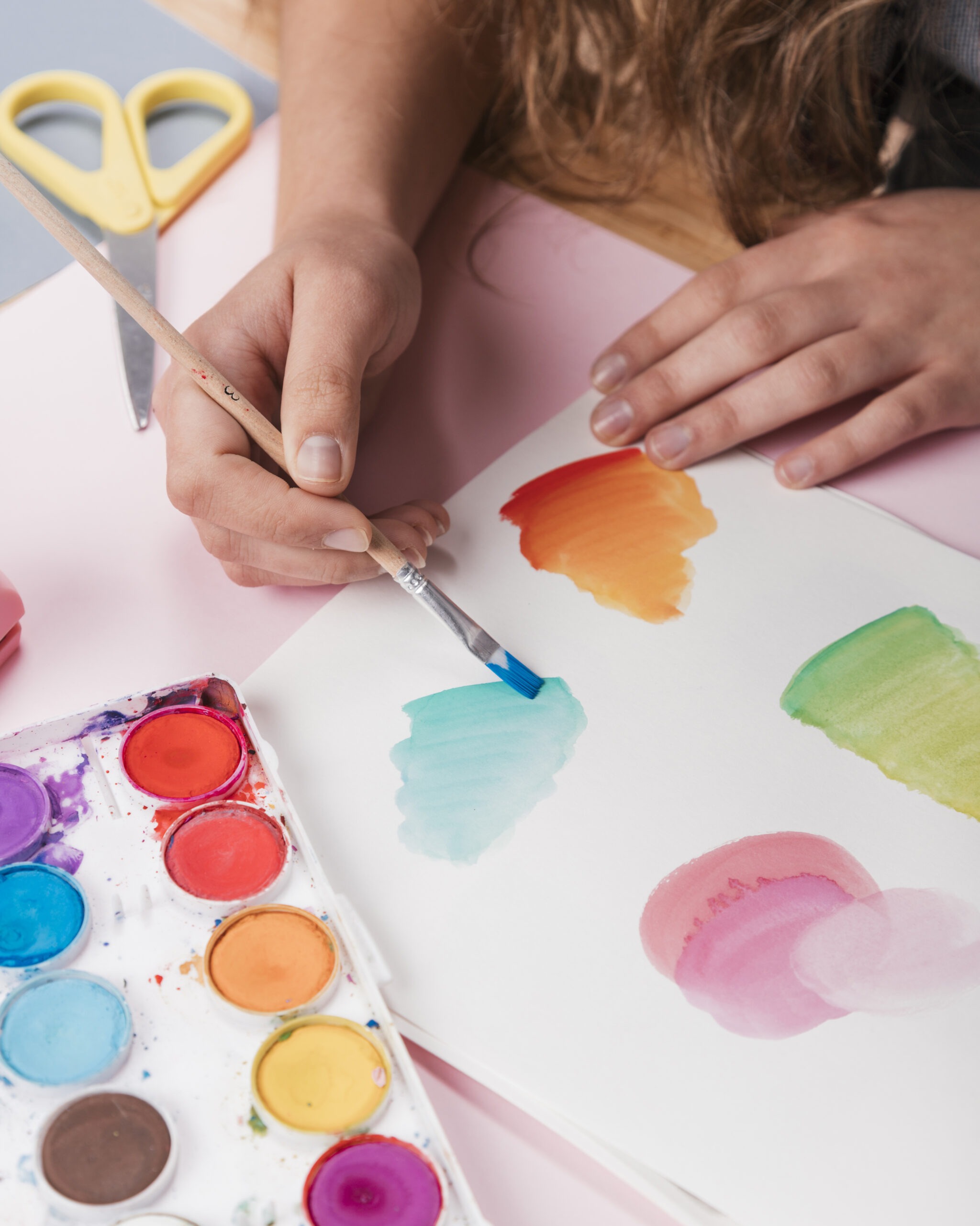 woman-hand-painting-abstract-design-white-paper-using-watercolor